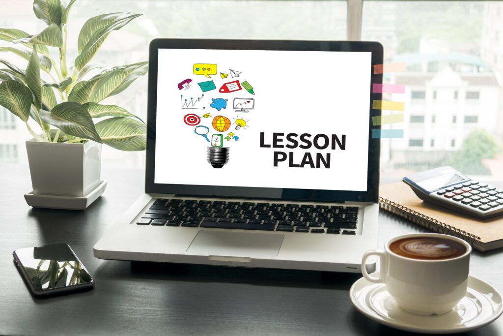 Laptop displaying "Lesson Plan" on desk.